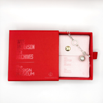 Load image into Gallery viewer, Asteroid City Charm in packaging white background
